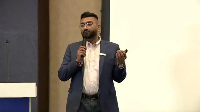 Ritesh Kumar speaking on stage